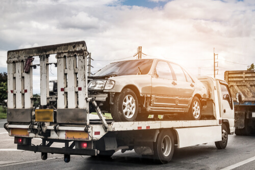 Car being towed by car towing company