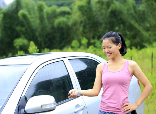 Girl with a remote opening a sedan - Nationwide Auto Transportation