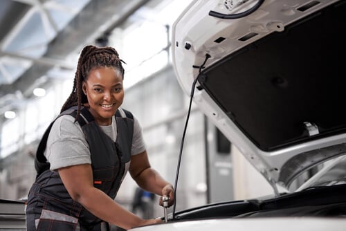 women mechanic fixing a car