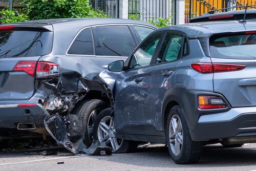 Two cars that have been involved in an accident. Car crashed into a parked vehicle. holiday driving vs auto shipping