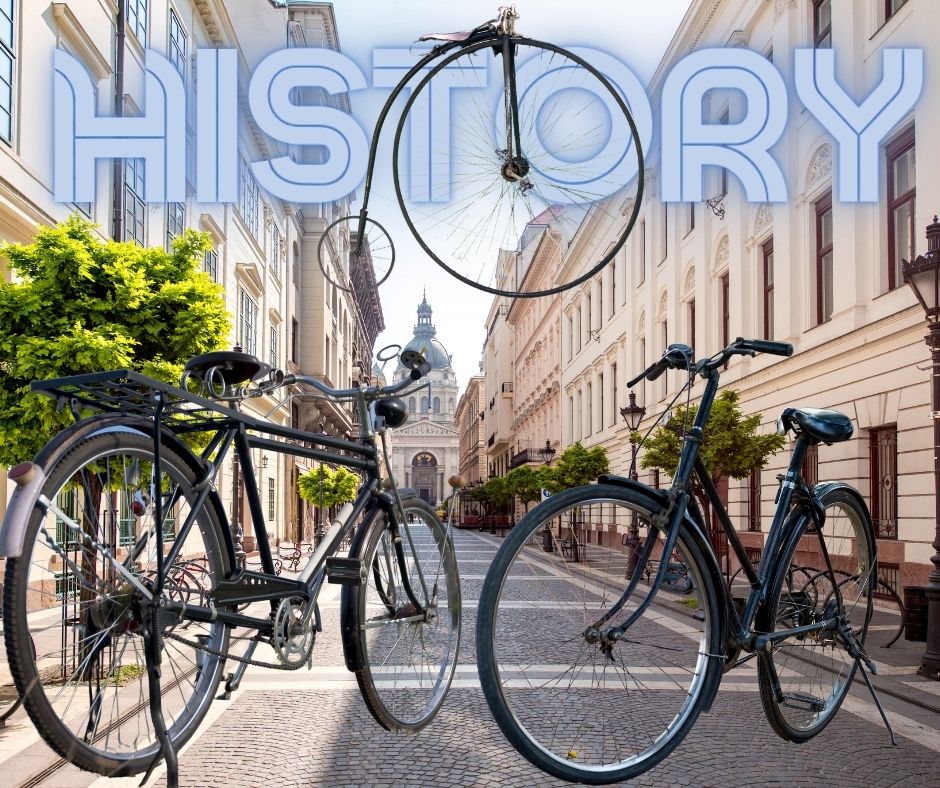 Vintage bicycle with a historical city background, representing the history of biking.