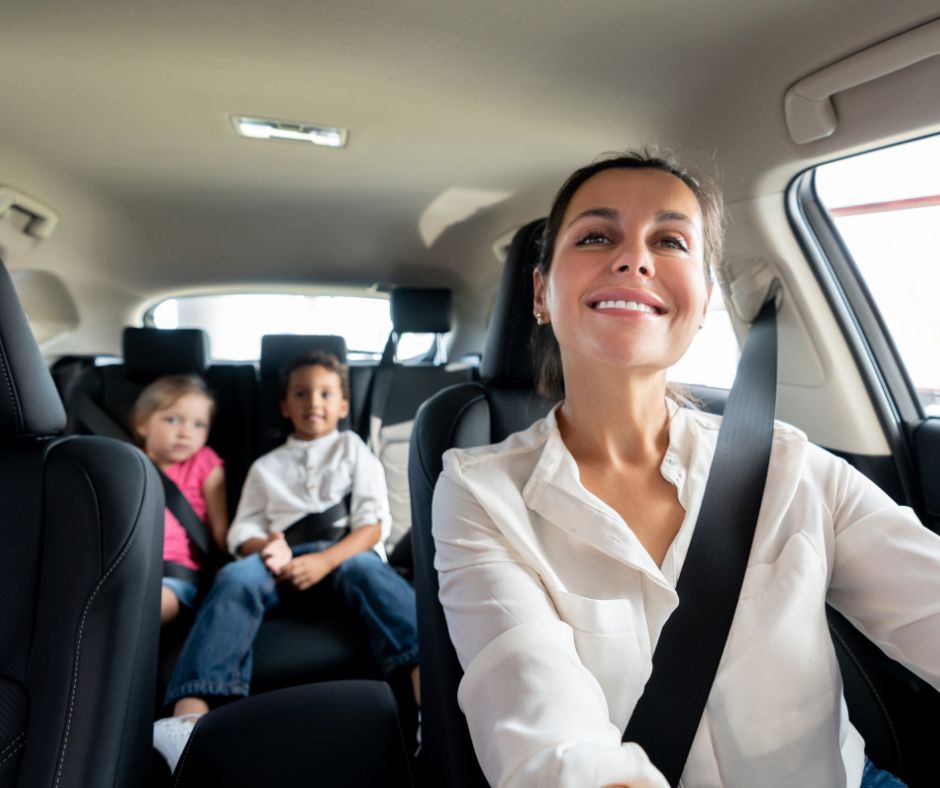 smiling mom and kids in a car