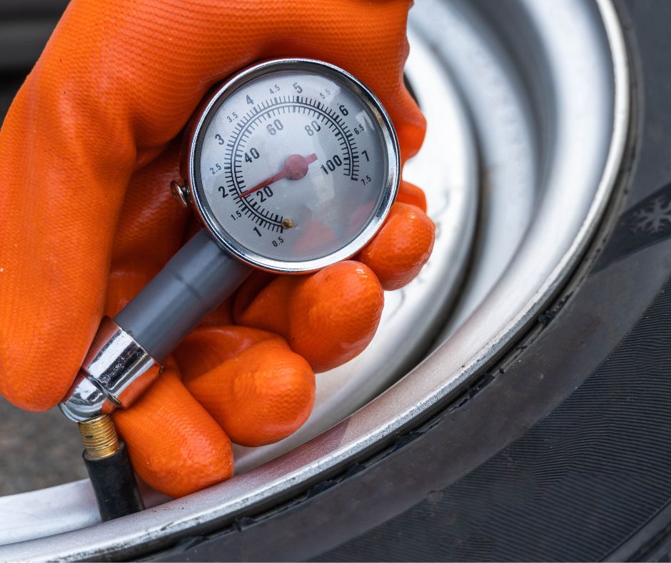 Close-up of a tire with a pressure gauge