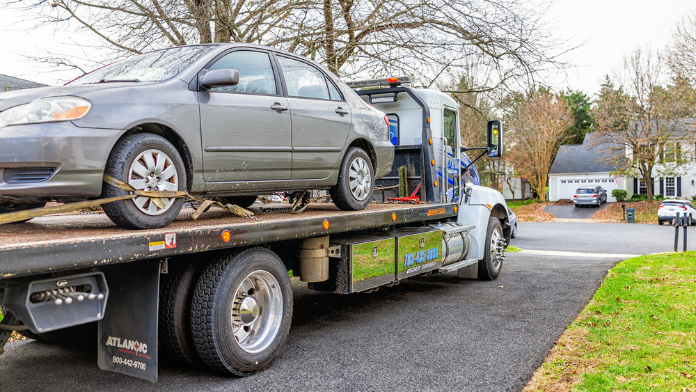 Image of a car being loaded onto a transport truck for Fast car transport