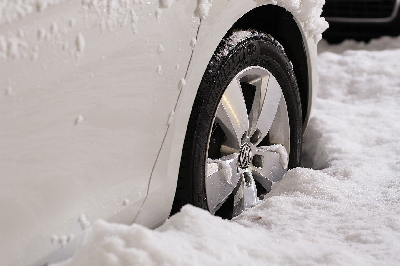 Close-up of a car tire in deep snow - snow driving safety is important.